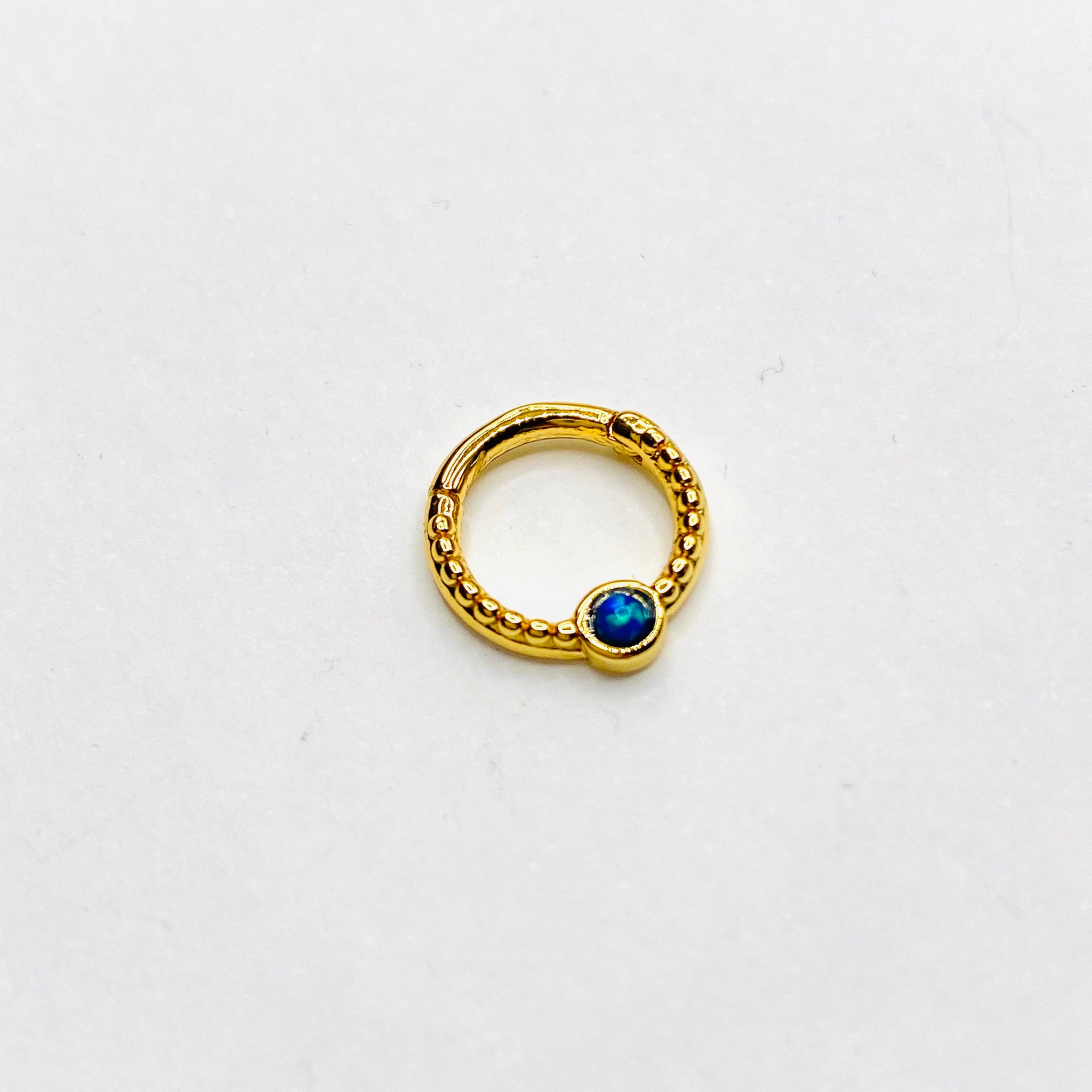 Gold opal septum clicker