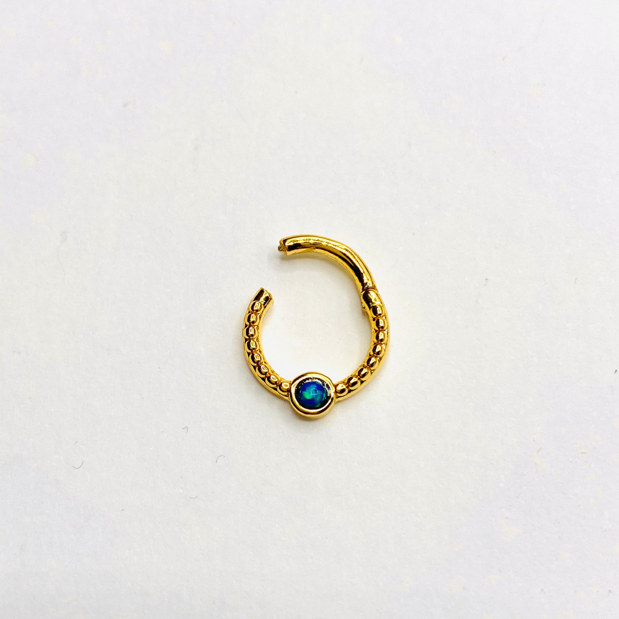 Gold opal septum clicker