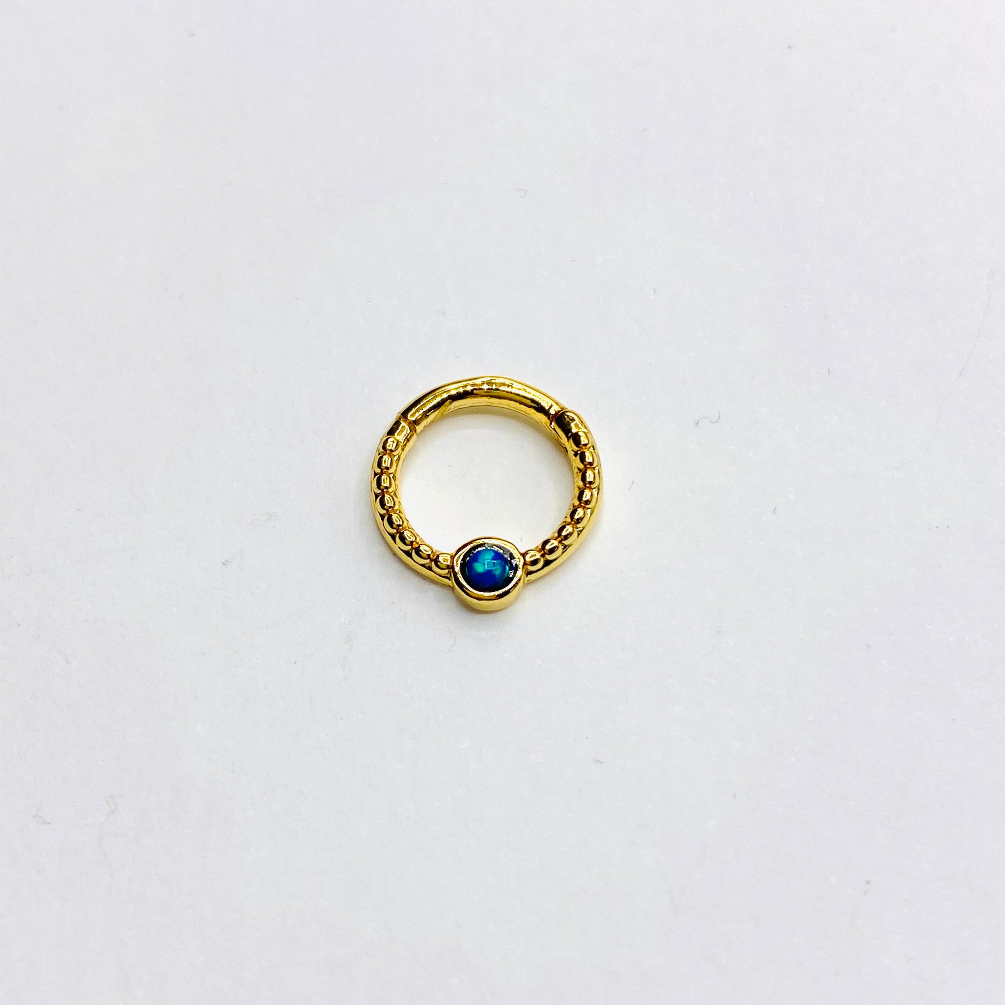 Gold opal septum clicker