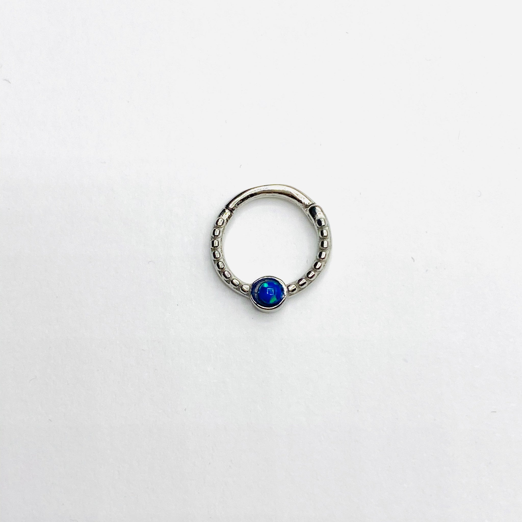 Gold opal septum clicker