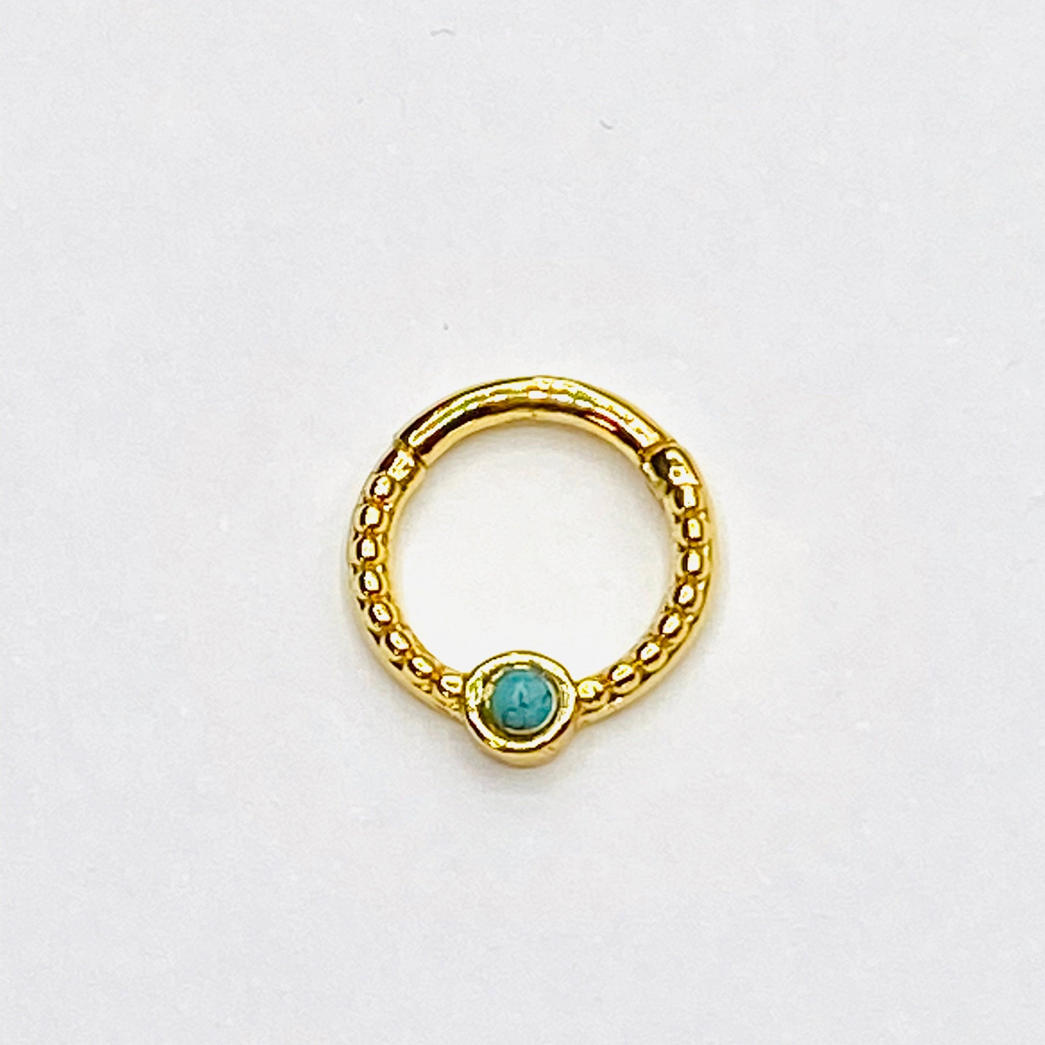 Gold septum with turqoise