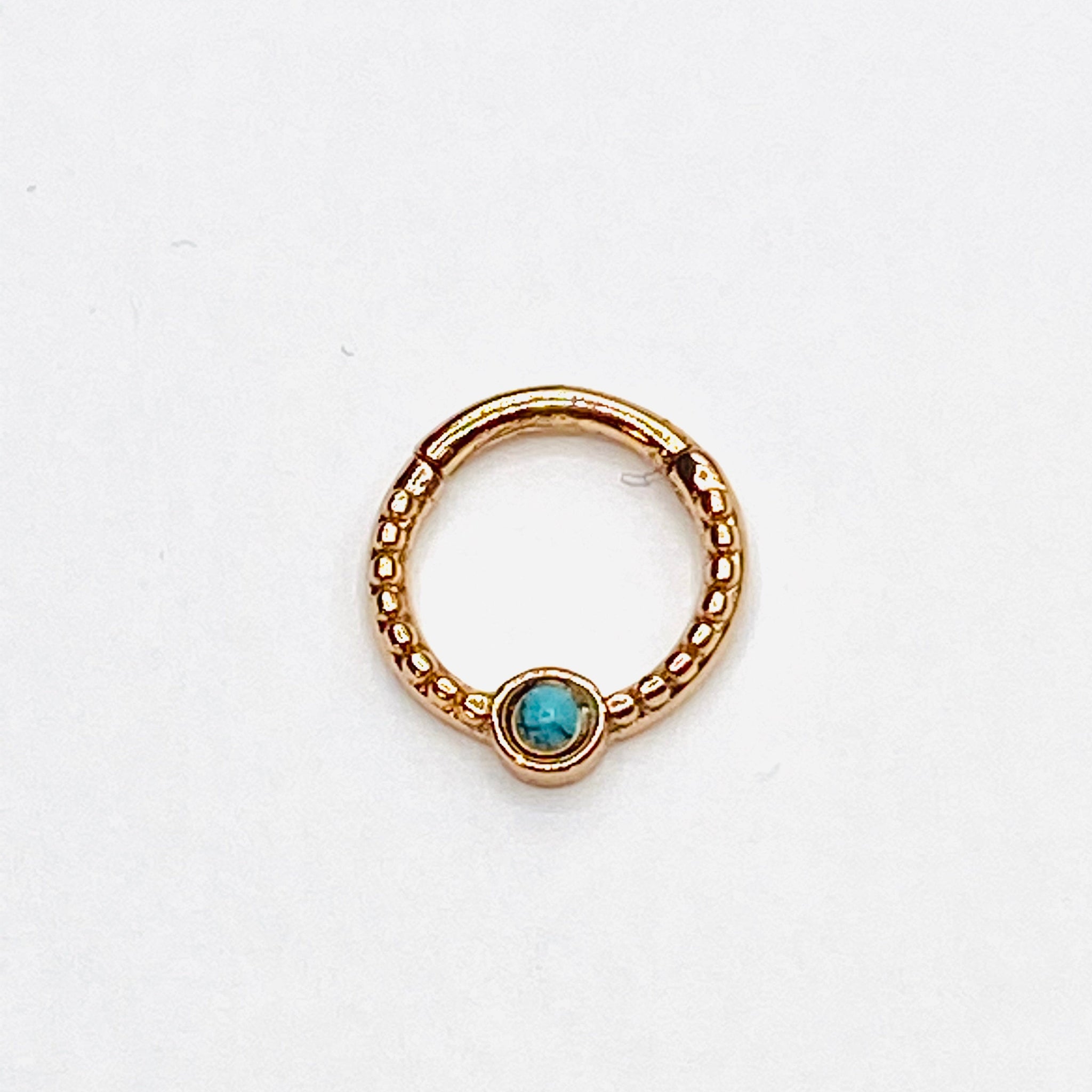 Gold septum with turqoise