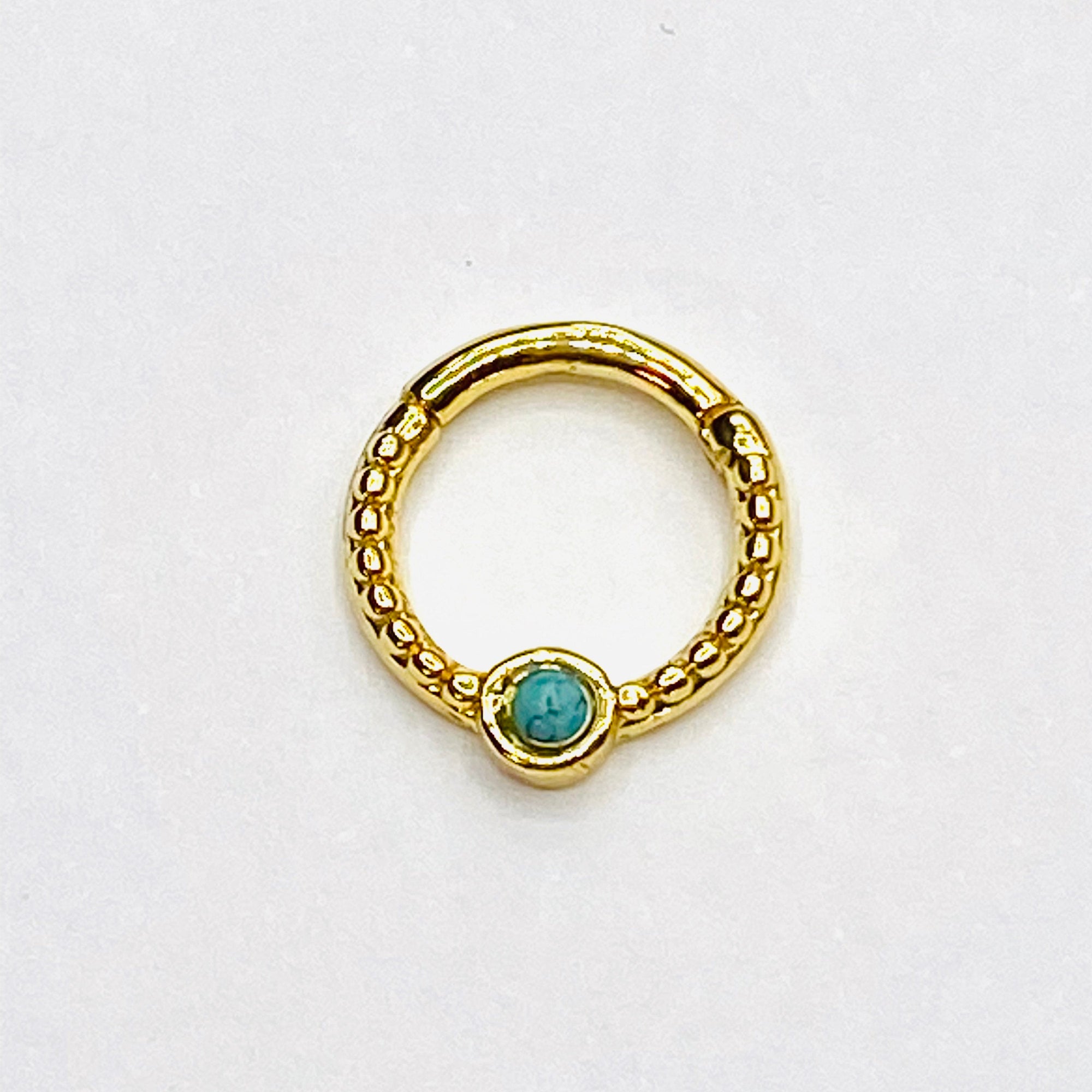 Gold septum with turqoise